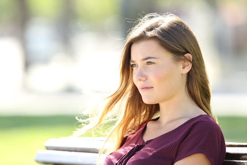 woman looking off to the side with a serious look