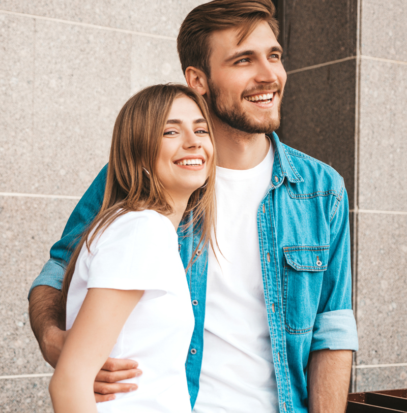 a young couple looking at the camera and smiling
